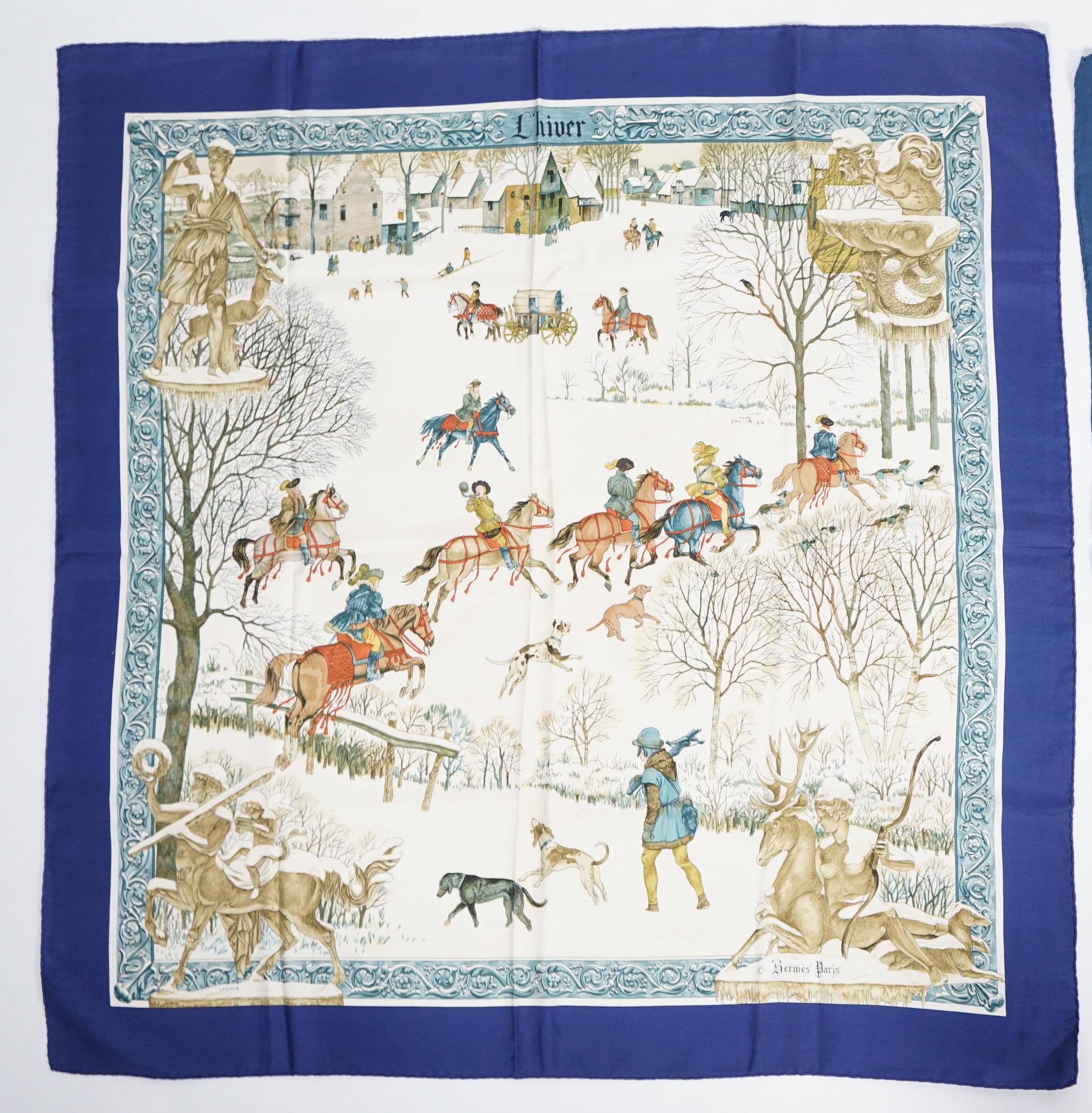 A Hermès 'Les Cles Key' blue border multicolour silk scarf and a Hermès Lhiver blue, white and gold silk scarf, both 90cm x 90cm